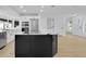 Modern kitchen featuring an island with marble countertops, stainless steel appliances, and ample lighting at 1484 Lake Francis Dr, Apopka, FL 32712