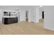 Open-concept kitchen with island, stainless appliances, and bright, expansive hardwood floors at 1484 Lake Francis Dr, Apopka, FL 32712