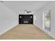 Bright living room with hardwood floors, a modern fireplace, and ample natural light from the windows at 1484 Lake Francis Dr, Apopka, FL 32712