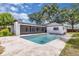 Backyard view of the sparkling pool and screened-in lanai of this charming single-Gathering home at 1484 Lake Francis Dr, Apopka, FL 32712