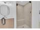 Walk-in shower with shower bench and modern fixtures, complemented by updated vanity and lighting at 1484 Lake Francis Dr, Apopka, FL 32712