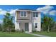 Charming two-story home featuring a covered front porch, grey color accents, and lush landscaping at 1510 Ridgeback Ln, Apopka, FL 32703