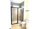 Stylish bathroom with walk-in shower, sleek glass door, and neutral tile at 15125 Grove Lake Dr, Winter Garden, FL 34787