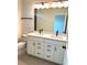 Bathroom features a double vanity, modern fixtures, and a sleek mirror at 15125 Grove Lake Dr, Winter Garden, FL 34787