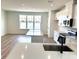 Bright kitchen features white cabinets, stainless appliances, a kitchen island, and wood floors at 15125 Grove Lake Dr, Winter Garden, FL 34787