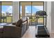 This covered balcony has a clear view of the community, has outside seating, and a treadmill at 1526 Euston Dr, Reunion, FL 34747