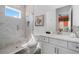 Bright bathroom with marble tile shower and modern vanity at 1526 Euston Dr, Reunion, FL 34747