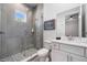 Modern bathroom with glass-enclosed shower, stylish vanity, and neutral tile at 1526 Euston Dr, Reunion, FL 34747