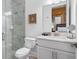 Clean and modern bathroom featuring a glass-enclosed shower, white marble tiling, and vanity at 1526 Euston Dr, Reunion, FL 34747