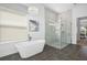 Stunning bathroom with a freestanding tub, marble walk-in shower, modern chandelier, and gray tile floor at 1526 Euston Dr, Reunion, FL 34747