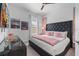 Chic bedroom with a black padded headboard, pink accents, and modern decor at 1526 Euston Dr, Reunion, FL 34747