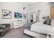 Bright bedroom features a modern bed frame, wall mounted TV, and neutral color palette at 1526 Euston Dr, Reunion, FL 34747