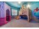 bedroom with custom built coral playhouse and castle bunkbed, featuring murals and carpet at 1526 Euston Dr, Reunion, FL 34747