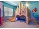 bedroom with custom castle bunkbed, featuring themed murals and carpet at 1526 Euston Dr, Reunion, FL 34747