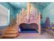 bedroom with custom castle bunkbed, featuring themed murals and carpet at 1526 Euston Dr, Reunion, FL 34747