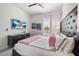 Stylish bedroom with a padded headboard, and a wall-mounted TV at 1526 Euston Dr, Reunion, FL 34747
