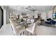 Expansive dining area with a large table, seating for fourteen, modern lighting, and seamless flow to the open living spaces at 1526 Euston Dr, Reunion, FL 34747