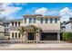 Stunning two-story home featuring a modern design with stone accents, lush landscaping, and a spacious two car garage at 1526 Euston Dr, Reunion, FL 34747