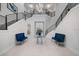 Stunning foyer with a grand staircase, modern chandelier, elegant decor, and marble floors, creating a luxurious entrance at 1526 Euston Dr, Reunion, FL 34747