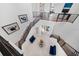 Bright foyer with a staircase, iron railings, chandelier, and modern decor at 1526 Euston Dr, Reunion, FL 34747