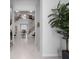Elegant foyer with soaring ceilings, modern staircase, marble floors, a decorative plant and views into other rooms at 1526 Euston Dr, Reunion, FL 34747