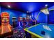 Fun-filled game room with air hockey, ski ball, arcade games, and colorful star carpet, designed for entertainment at 1526 Euston Dr, Reunion, FL 34747