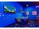 Vibrant game room featuring an air hockey table and colorful, star-patterned carpet, perfect for Gathering fun at 1526 Euston Dr, Reunion, FL 34747