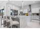 Modern kitchen featuring a large island with bar seating, stainless steel appliances, and sleek cabinetry with pendant lighting at 1526 Euston Dr, Reunion, FL 34747