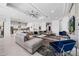 Bright open-plan living room featuring plush grey sectional sofa, modern ceiling fan, and direct kitchen access at 1526 Euston Dr, Reunion, FL 34747