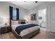 Comfortable bedroom with stylish décor, a nightstand, and access to an ensuite bathroom at 1526 Euston Dr, Reunion, FL 34747