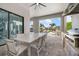 Outdoor dining area with seating for eight, a built-in grill, and views of the pool and backyard at 1526 Euston Dr, Reunion, FL 34747