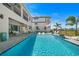 A spacious backyard pool featuring in-water loungers, stylish seating, and modern architecture, creating an ideal outdoor oasis at 1526 Euston Dr, Reunion, FL 34747