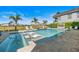 A luxurious pool and spa area with lounge chairs, a cozy cabana, and a backdrop of lush landscaping, perfect for relaxation at 1526 Euston Dr, Reunion, FL 34747