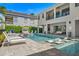 A bright and inviting pool area with lounge chairs, a stylish cabana, and modern architectural design, perfect for outdoor relaxation at 1526 Euston Dr, Reunion, FL 34747