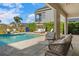 Relaxing pool area with comfortable seating, a cozy cabana, and views of the lush green surroundings at 1526 Euston Dr, Reunion, FL 34747