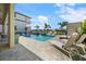 Inviting pool area with lounge chairs and lush landscaping, creating a perfect oasis for relaxation at 1526 Euston Dr, Reunion, FL 34747