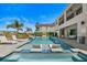 A pristine pool area with comfortable lounge chairs, tropical landscaping, and a modern home, perfect for enjoying the sunny outdoors at 1526 Euston Dr, Reunion, FL 34747