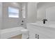Bright bathroom featuring a bathtub, toilet, and vanity with modern fixtures at 15300 Sw 62Nd Ct, Ocala, FL 34473