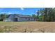 Rear exterior of a single-Gathering home featuring a minimalist design with gray siding at 15300 Sw 62Nd Ct, Ocala, FL 34473
