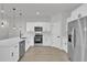 Modern kitchen featuring white cabinetry, stainless steel appliances, and a breakfast bar at 15300 Sw 62Nd Ct, Ocala, FL 34473