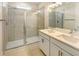 Modern bathroom with double vanity, quartz countertop, and a glass enclosed shower at 1537 Heritage Pl, Oviedo, FL 32765