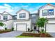 Charming new construction two-story townhouse with white and gray exterior paint scheme at 1537 Heritage Pl, Oviedo, FL 32765