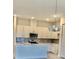 Modern kitchen featuring white cabinets, stainless steel appliances, and quartz countertop at 1537 Heritage Pl, Oviedo, FL 32765