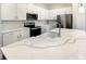 Bright kitchen featuring white cabinets, stainless steel appliances, and marble-look countertops at 1537 Heritage Pl, Oviedo, FL 32765