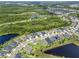 Aerial view of community with green space, lakes, ponds, and rows of similar single-Gathering homes at 17676 Passionflower Cir, Clermont, FL 34714