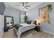 Calm bedroom with a large mirror, botanical wall decor, and a ceiling fan for added comfort at 17676 Passionflower Cir, Clermont, FL 34714