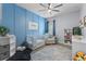 Cozy Bedroom with a blue accent wall, crib, comfortable chair, and plenty of storage for books and toys at 17676 Passionflower Cir, Clermont, FL 34714