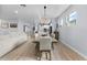 Open-concept dining room with a modern table, chairs, elegant lighting, and seamless flow to the living spaces at 17676 Passionflower Cir, Clermont, FL 34714