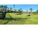 Community dog park with a grass area, shade structures, and play features for pets to enjoy at 17676 Passionflower Cir, Clermont, FL 34714