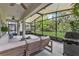 Relaxing screened patio with an outdoor seating area, ceiling fans, and views of the backyard at 17676 Passionflower Cir, Clermont, FL 34714